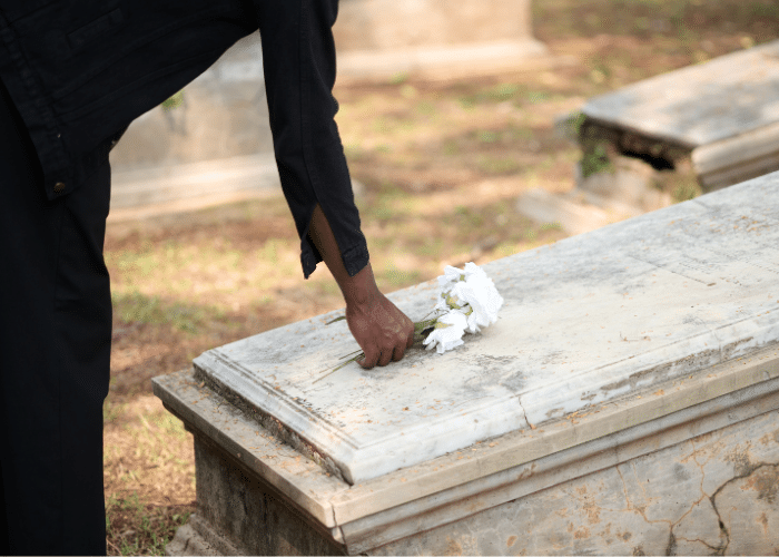 Placing flowers on a casket